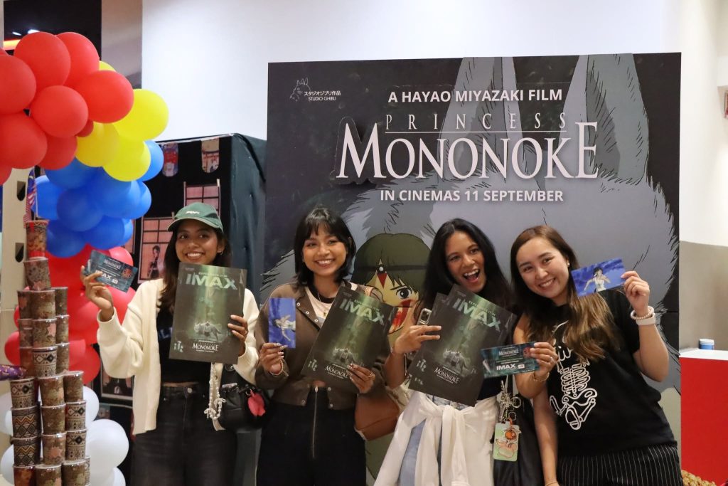 Group of fans smiling and holding Princess Mononoke posters during the TGV Ghibli fan event. | TGV Blog